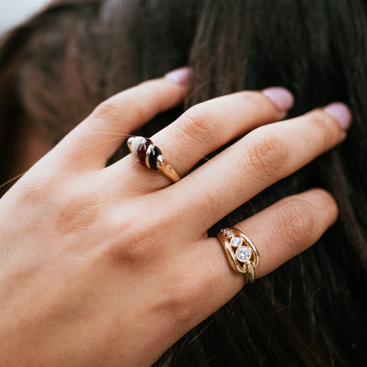Hand wearing solid gold trio dome ring handcrafted by SOIL Jewelry