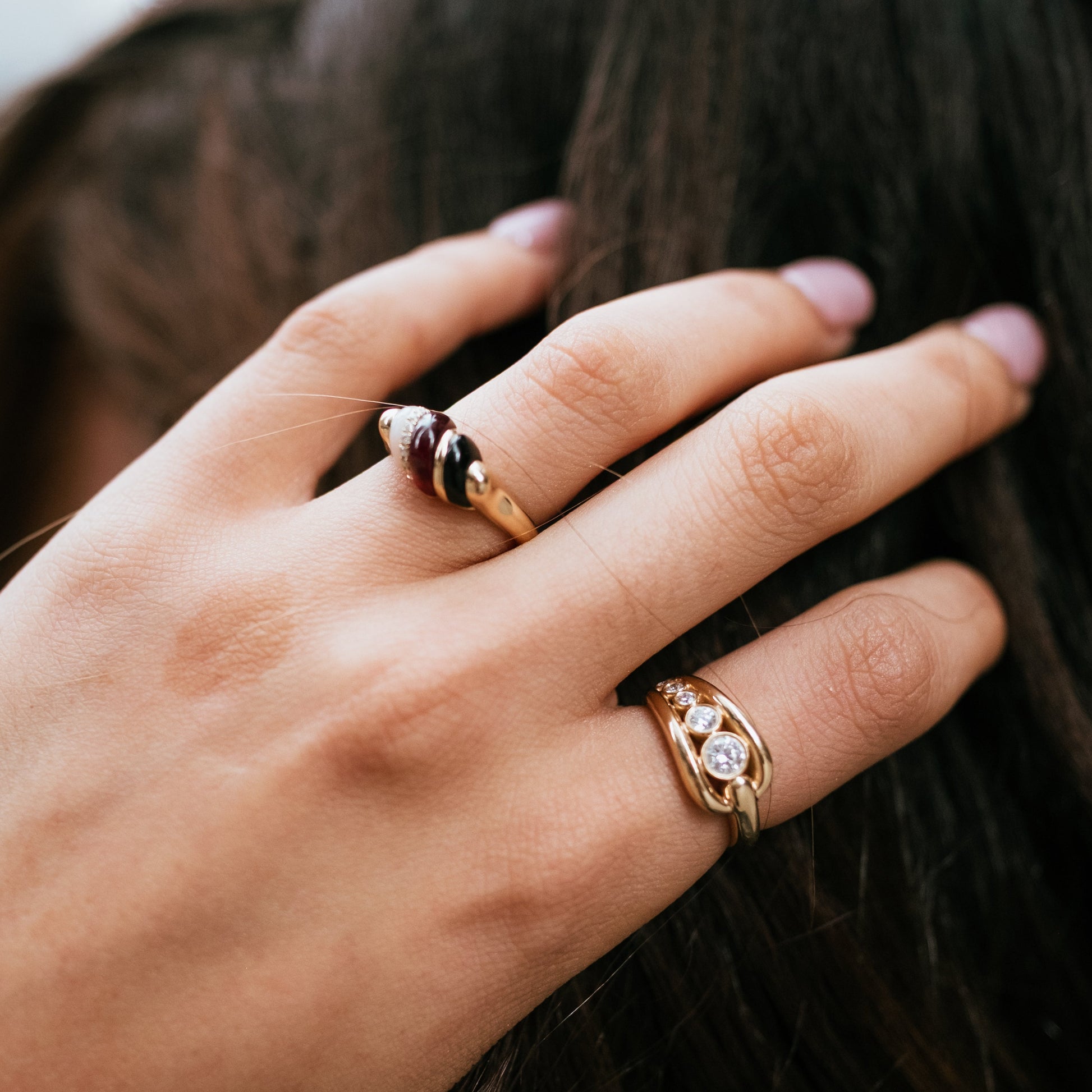 Hand wearing solid gold trio dome ring handcrafted by SOIL Jewelry