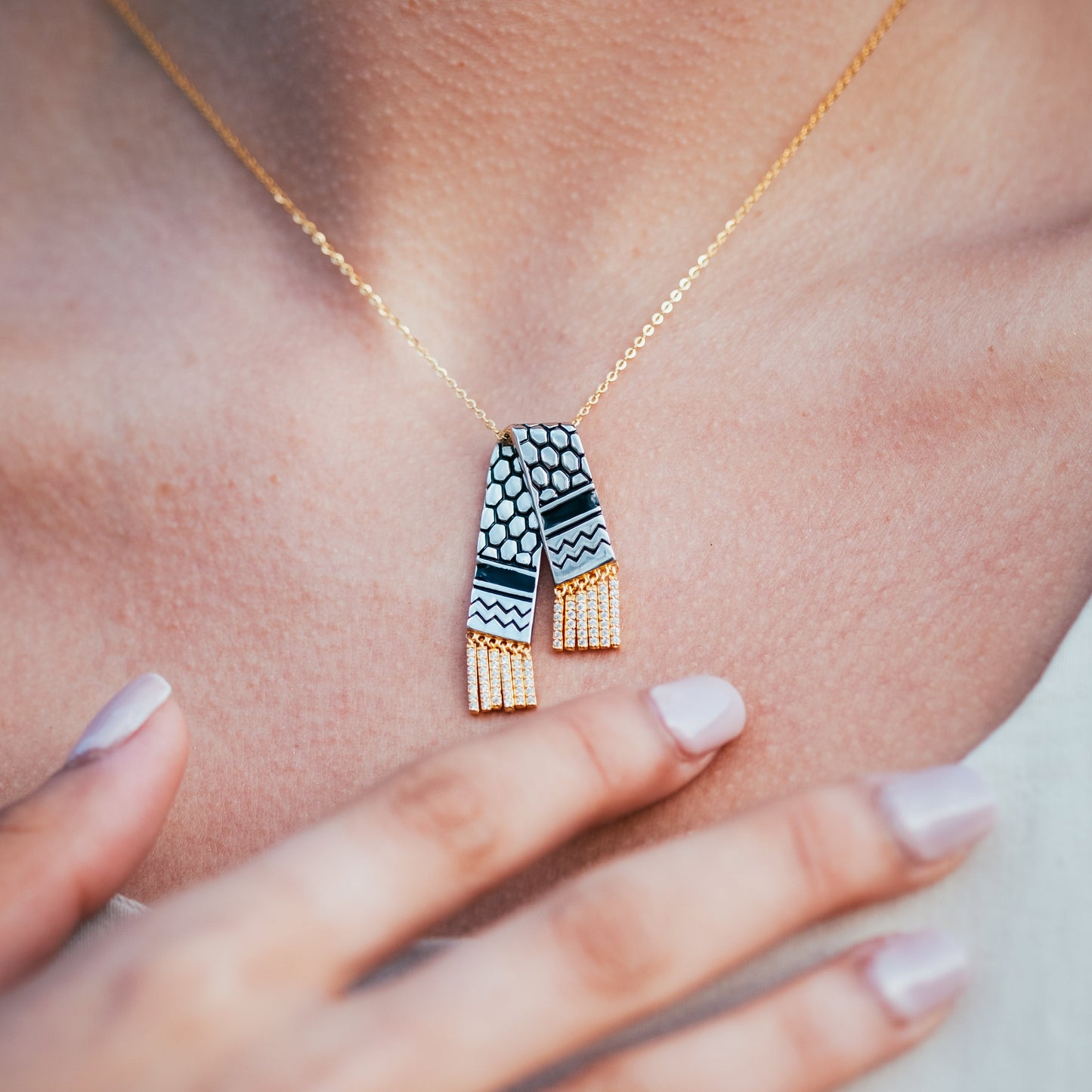 Necklace with a geometric pendant worn by a person