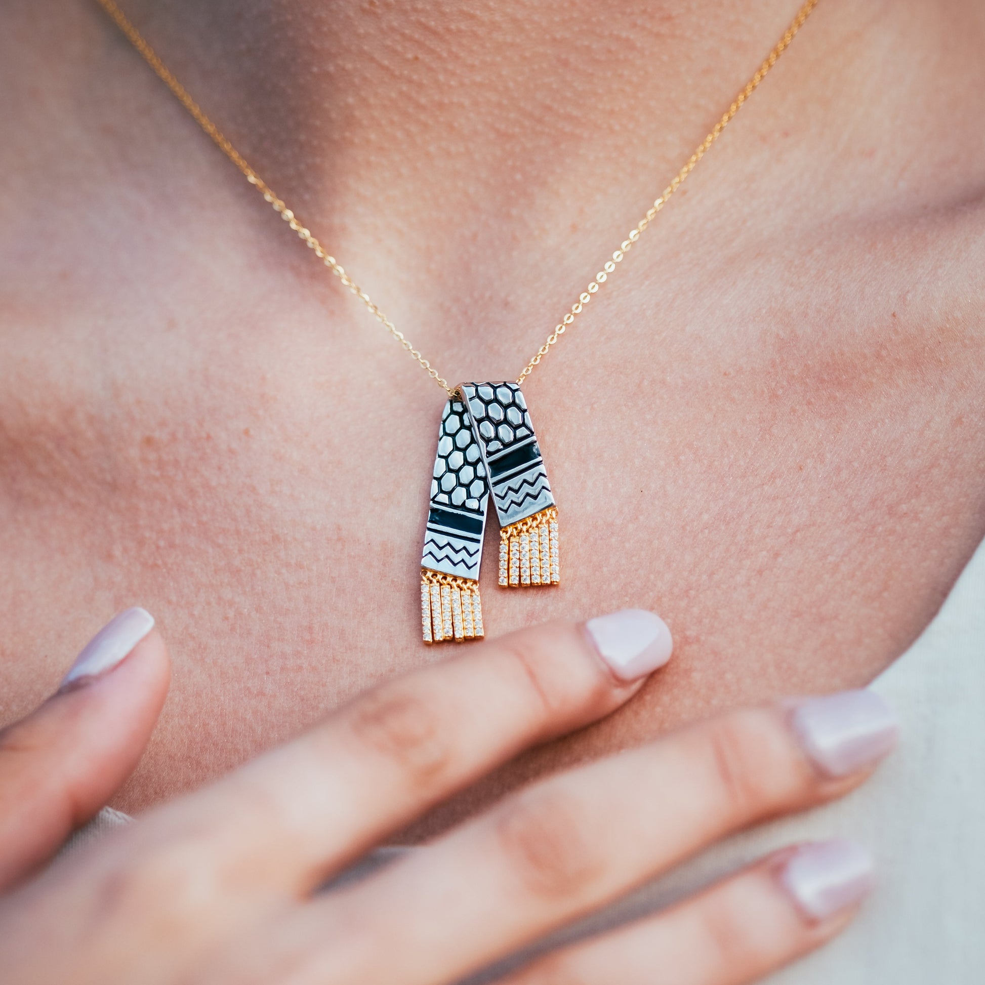 Necklace with a geometric pendant worn by a person